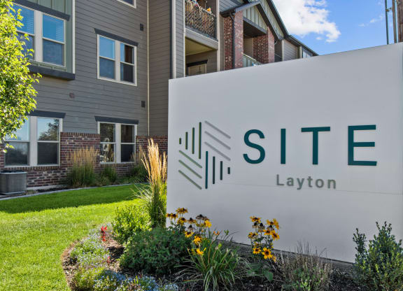 a sign that says site layton in front of a building