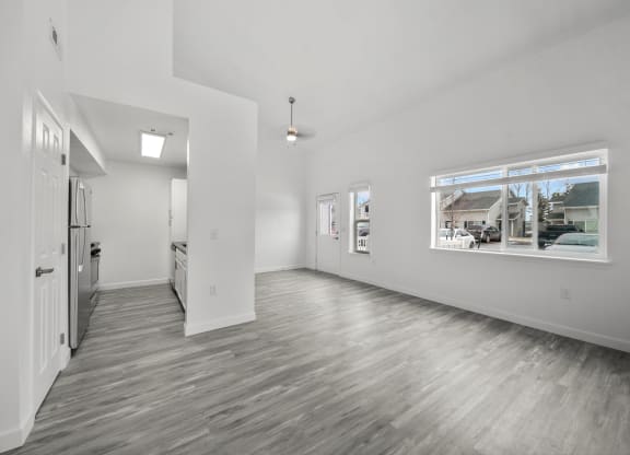 an empty room with a large window and white walls