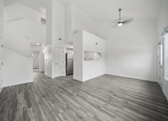 a bedroom with hardwood floors and white walls