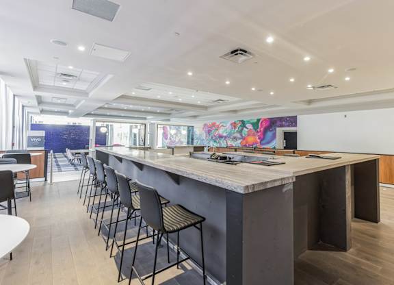 A long bar with chairs on either side.