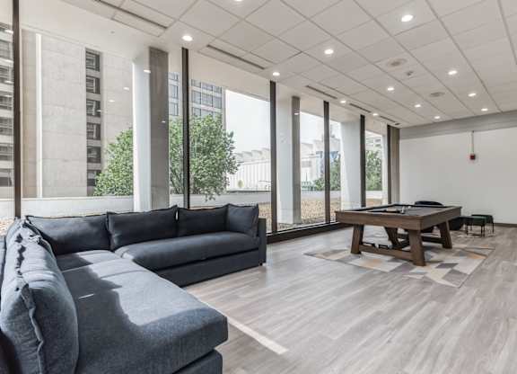 A modern living room with a grey sofa and a wooden coffee table.