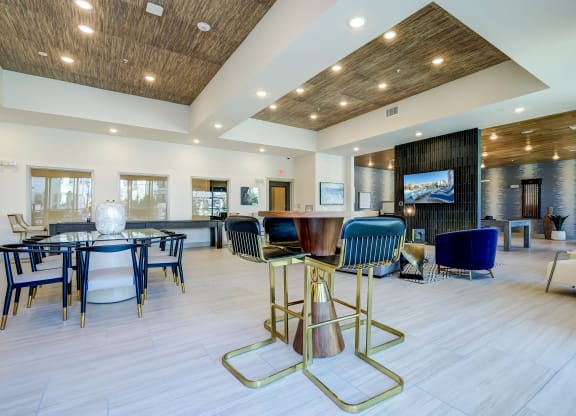 The Dylan resident clubhouse with tables and chairs and a flat screen tv
