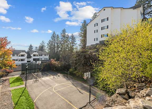 the view of a basketball court with a building in the background