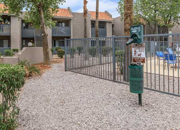 A gated community with a sign on a pole.