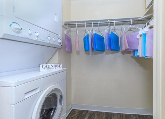 A laundry room with a washer and dryer and a sign that says "Laundry Its Load of Fire".