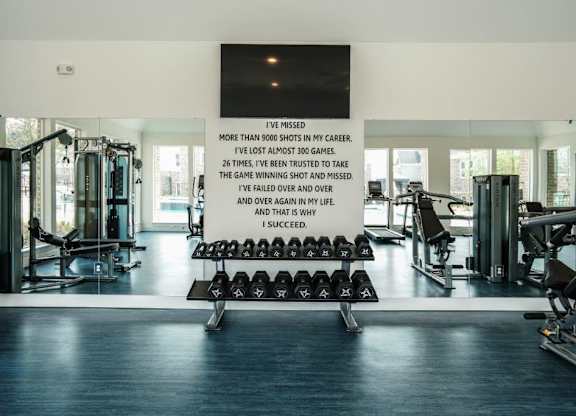 A gym with a sign that reads "I succeed" in the middle of it.