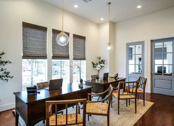 A dining room with a wooden table and chairs.