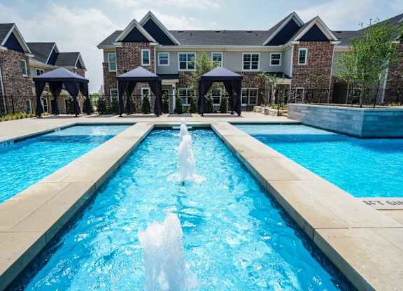 A large pool with a waterfall in the middle of it.