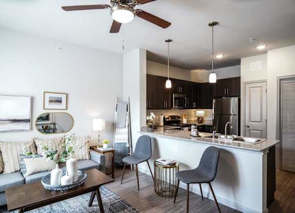 A modern kitchen with a dining table and chairs.
