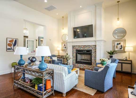A living room with a fireplace and a TV mounted above it.