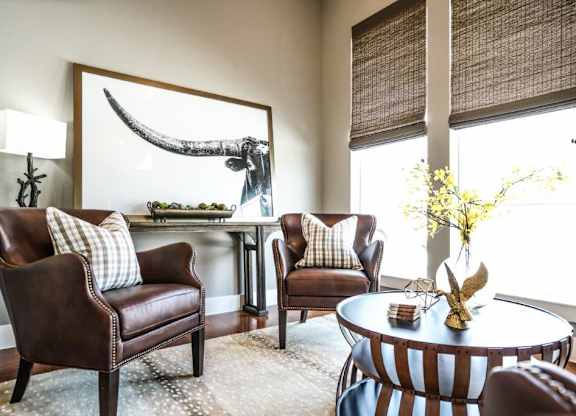 A living room with a large painting of a whale above a table.