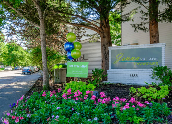 a building with a sign and balloons in front of it