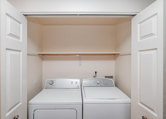 a washer and dryer in a laundry room with white doors