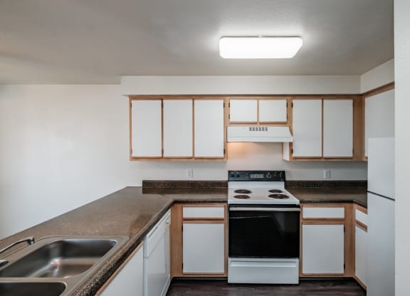 a kitchen with white cabinets and a black stove top oven