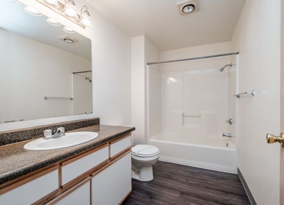 a bathroom with a toilet sink and bathtub