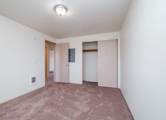 a bedroom with a carpeted floor and white walls
