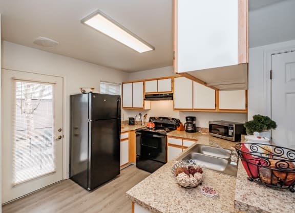 the kitchen has granite countertops and stainless steel appliances