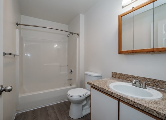 a bathroom with a toilet sink and shower