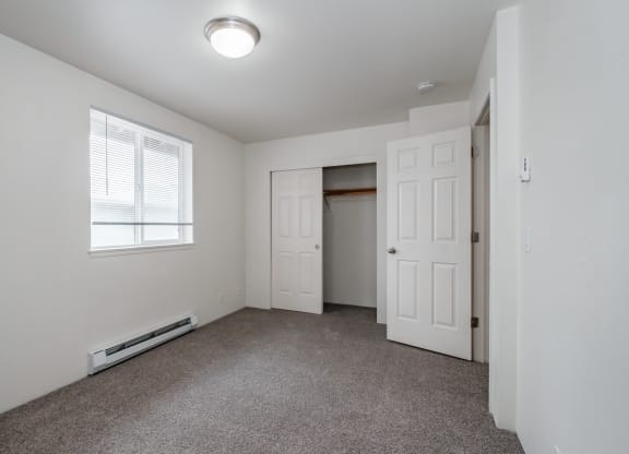 a bedroom with a carpeted floor and white walls