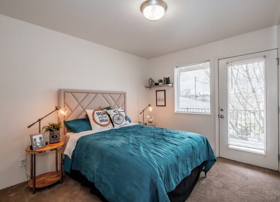 a bedroom with a bed and two windows