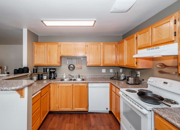 a kitchen with wooden cabinets and granite countertops