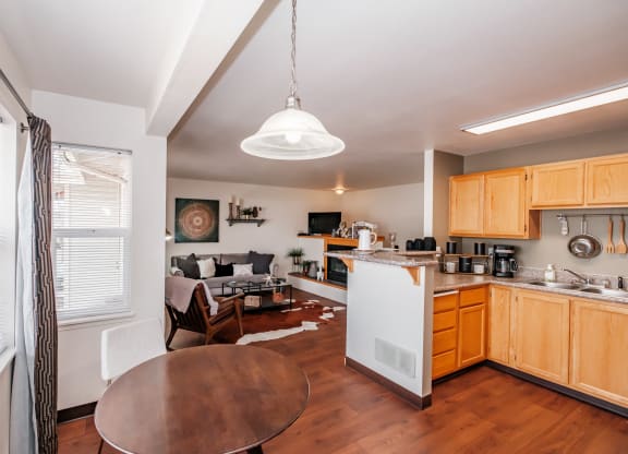 a kitchen and living room with wood floors and white appliances
