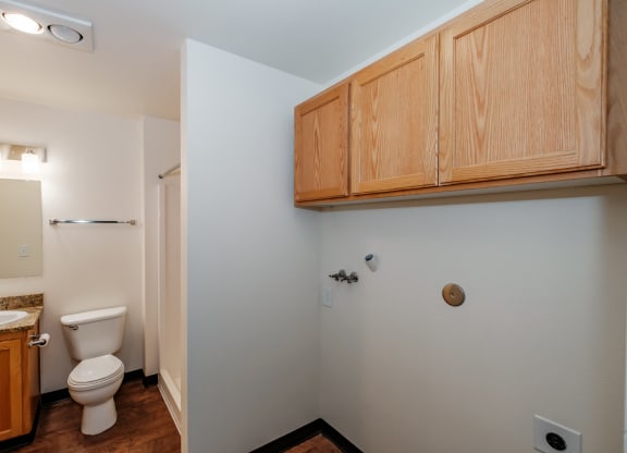 a bathroom with a toilet sink and mirror
