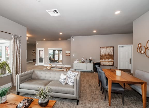 a living and dining room area with a couch table and chairs