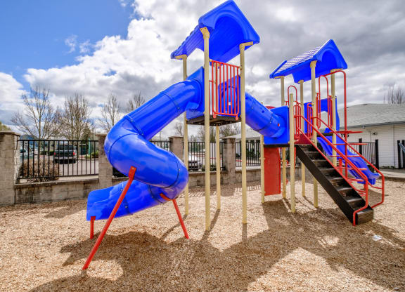a playground with a blue and red slide