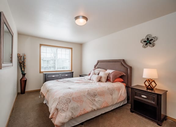 a bedroom with a bed and two night stands