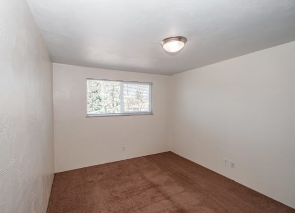 a small room with white walls and a small window