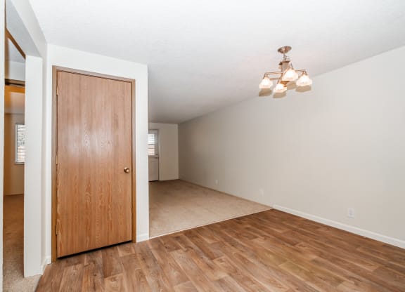 a living room with hardwood floors and a wooden door