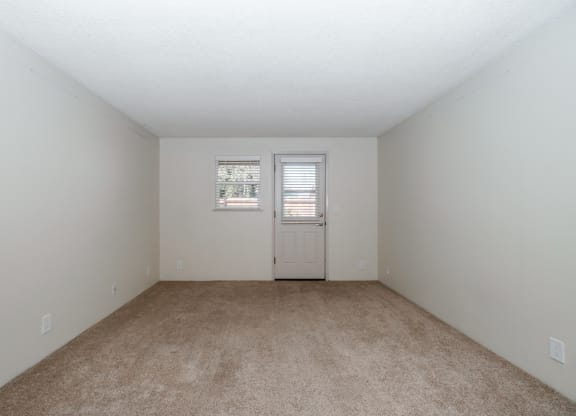 a bedroom with a carpeted floor and white walls