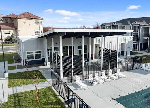 A modern building with a pool in front.