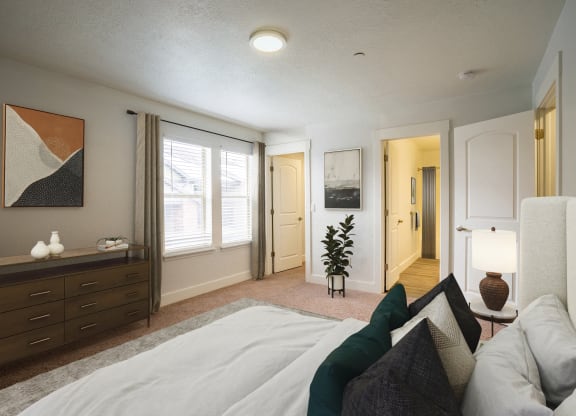 a bedroom with a large bed and a dresser