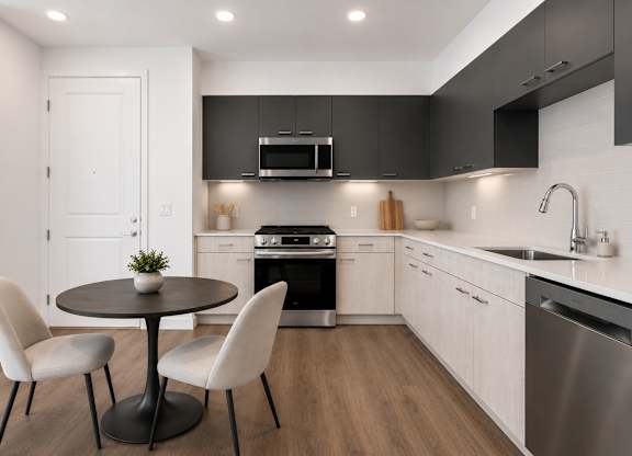 A modern kitchen with a round table and chairs.