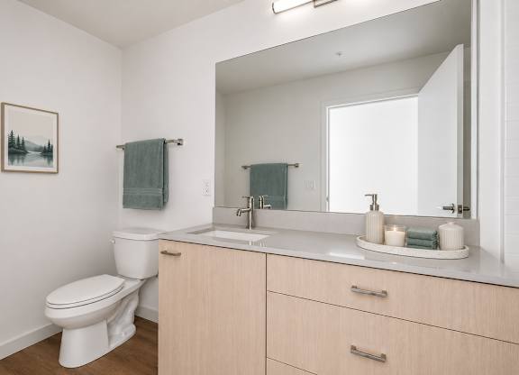 A white toilet sits next to a sink in a bathroom.