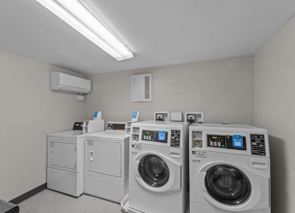A row of washing machines in a laundromat.