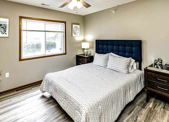 A bedroom with a large bed and a window.