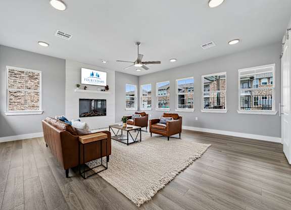 A spacious living room with a flat screen TV and a large window.