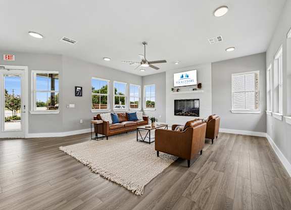 A living room with a couch, a rug, and a television.