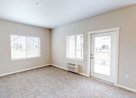 an empty room with a door and a window