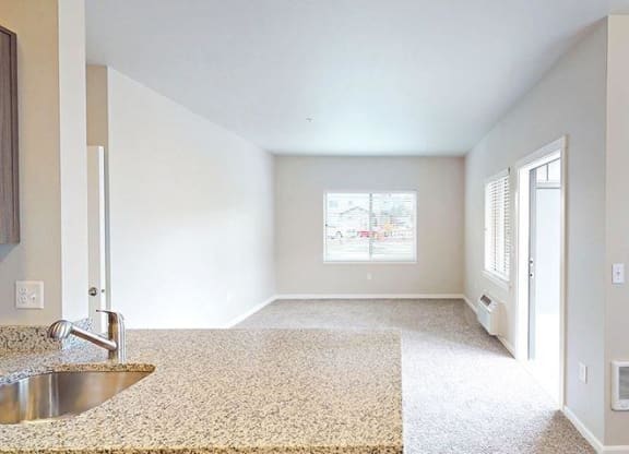 an empty room with a sink and a window