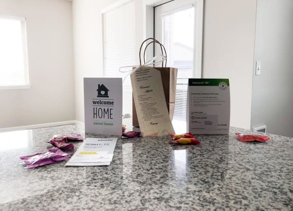 three bags sitting on a counter with some clothes on it