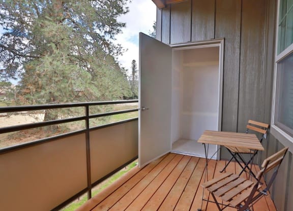 a balcony with a table and chairs on it