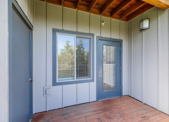 A blue door and window on a white building.