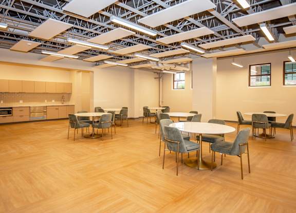 A room with a table and chairs in it.