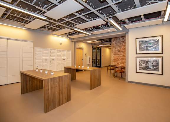 A room with a brick wall and wooden furniture.