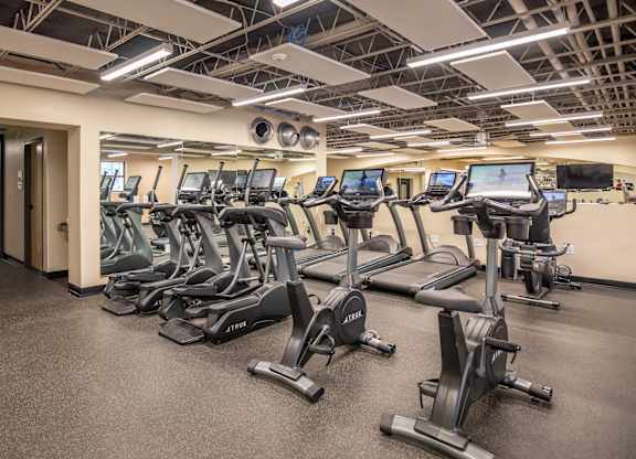 A gym with treadmills and elliptical machines.