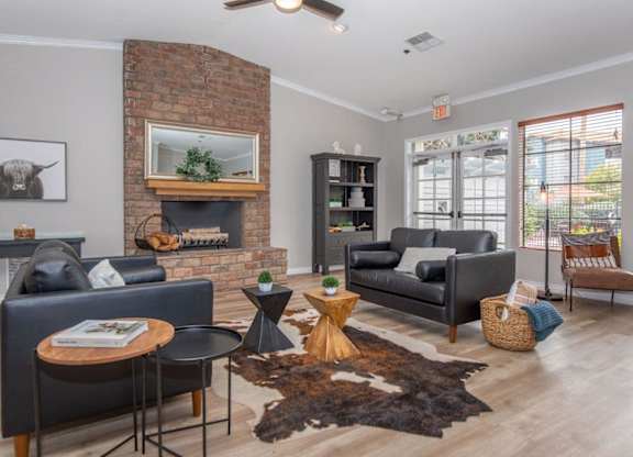 A living room with a fireplace and a cow picture on the wall.